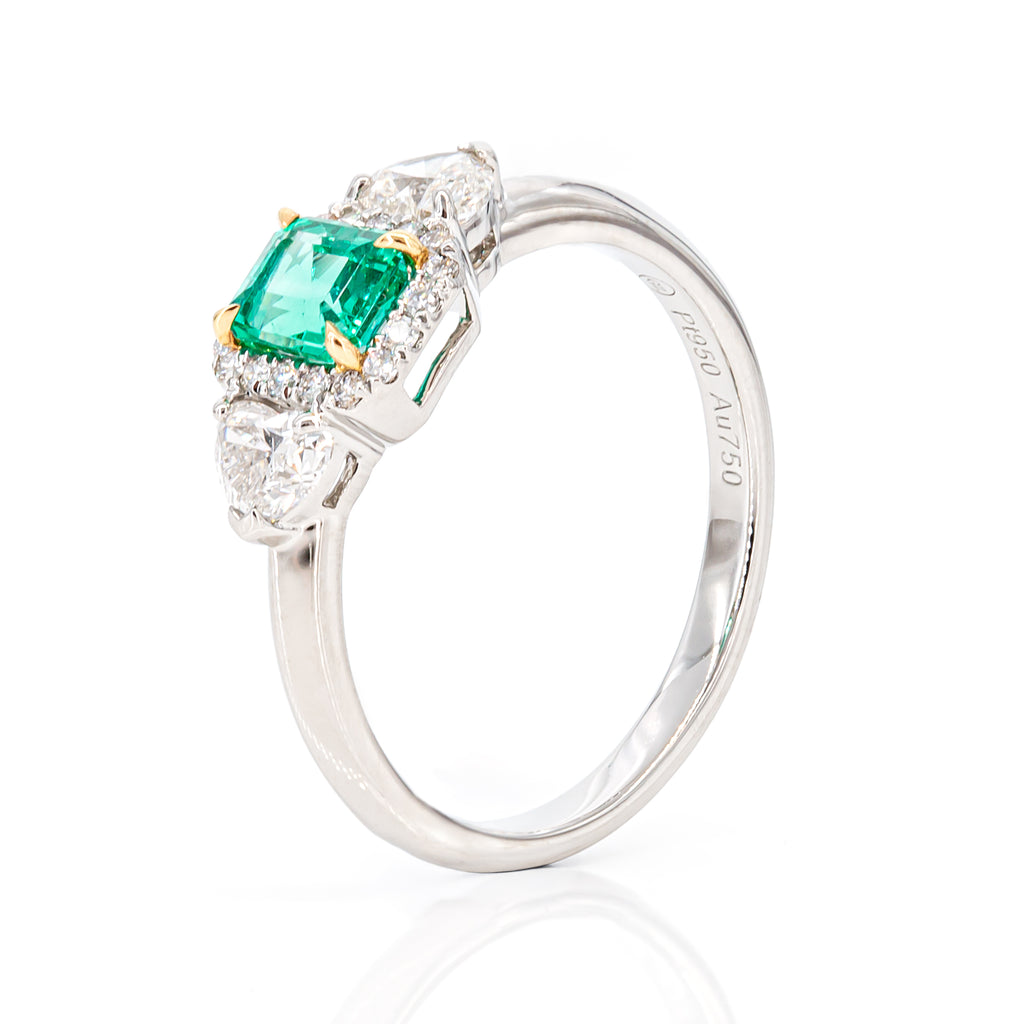 Angled shot of emerald diamond ring highlighting craftsmanship