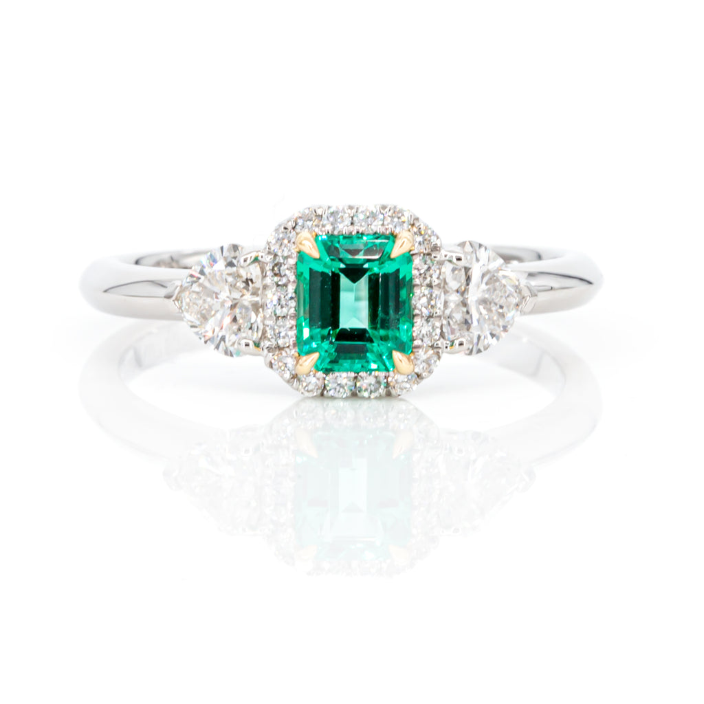 Top view of 0.49ct emerald-cut diamond set in platinum and yellow gold with elegant design