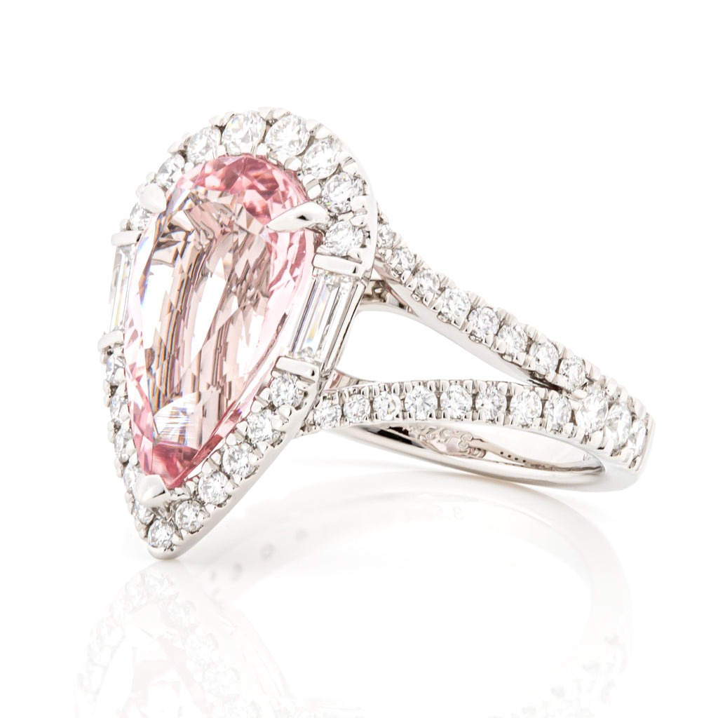 Angled perspective of morganite and diamond halo ring in PT950 platinum