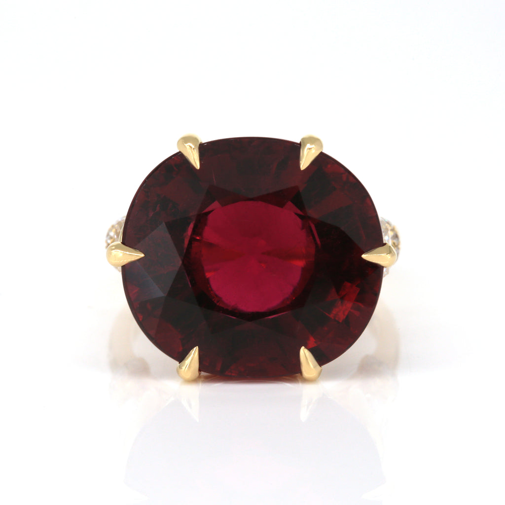 Close-up of rubellite gemstone and diamond craftsmanship in gold ring