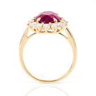 Side profile of 4.01ct pinkish-red oval ruby diamond ring in 18K yellow gold, IGI certified, showcasing elegant setting and diamond accents