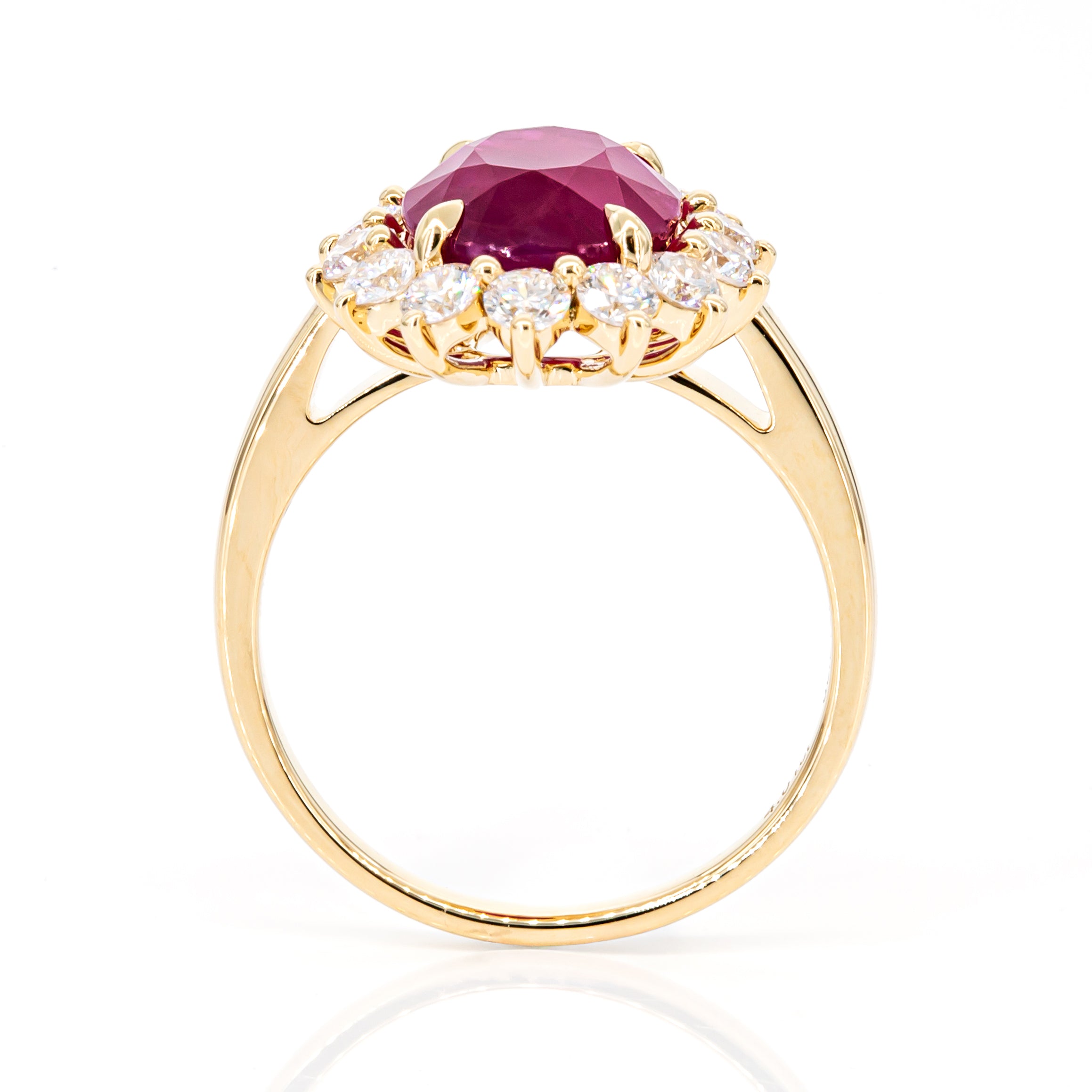 Side profile of 4.01ct pinkish-red oval ruby diamond ring in 18K yellow gold, IGI certified, showcasing elegant setting and diamond accents