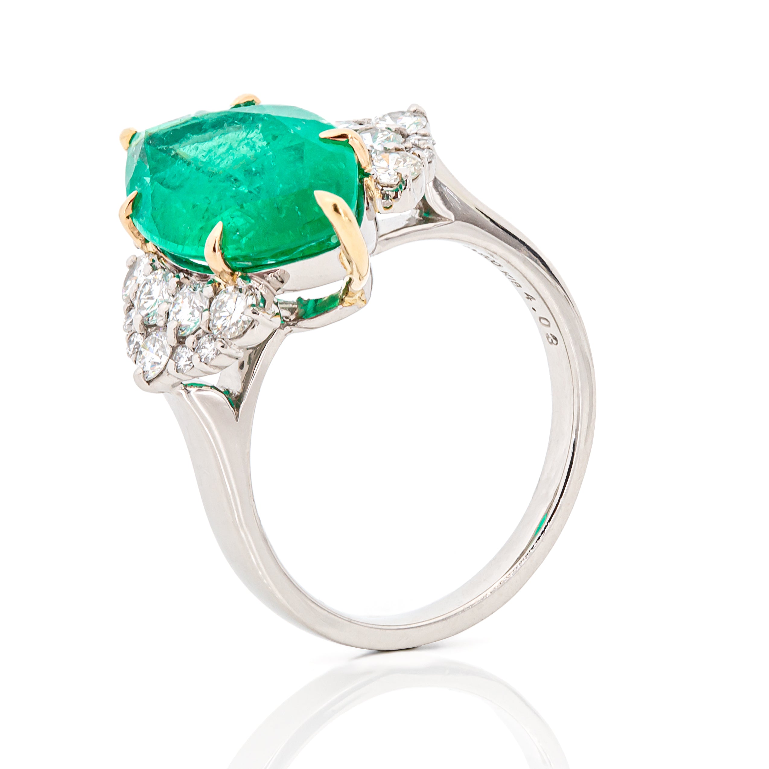 Angled perspective of Colombian emerald and diamond ring in PT900 platinum and 18K yellow gold