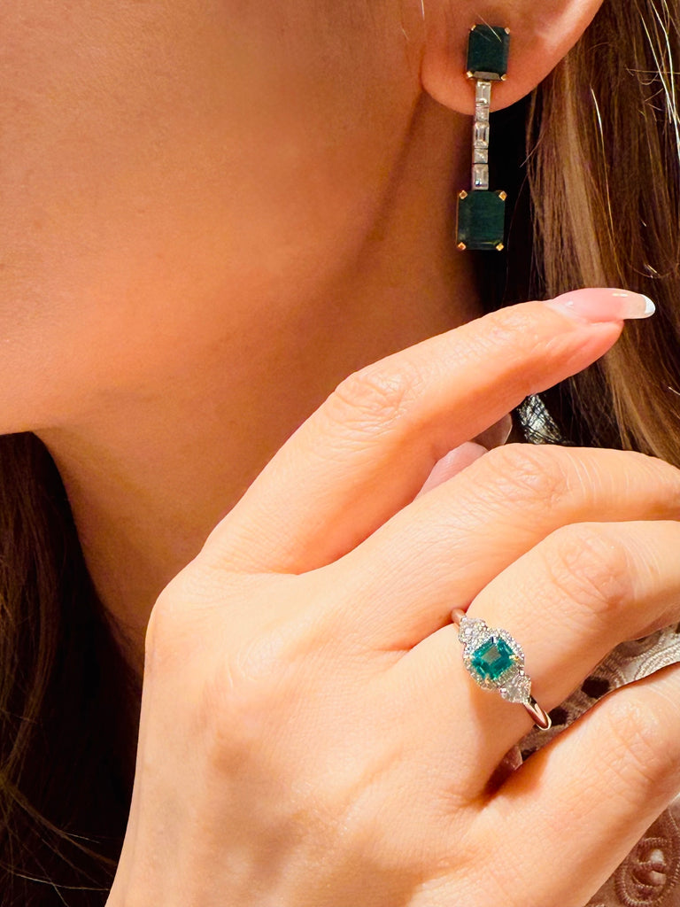 Emerald diamond ring worn on hand, featuring PT950 platinum and 18K yellow gold design